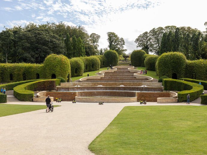 A tiered water cascade and fountains in formal gardens