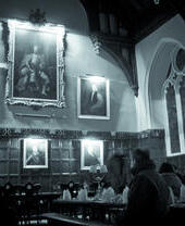 People sat in a historic hall on a ghost tour of Oxford