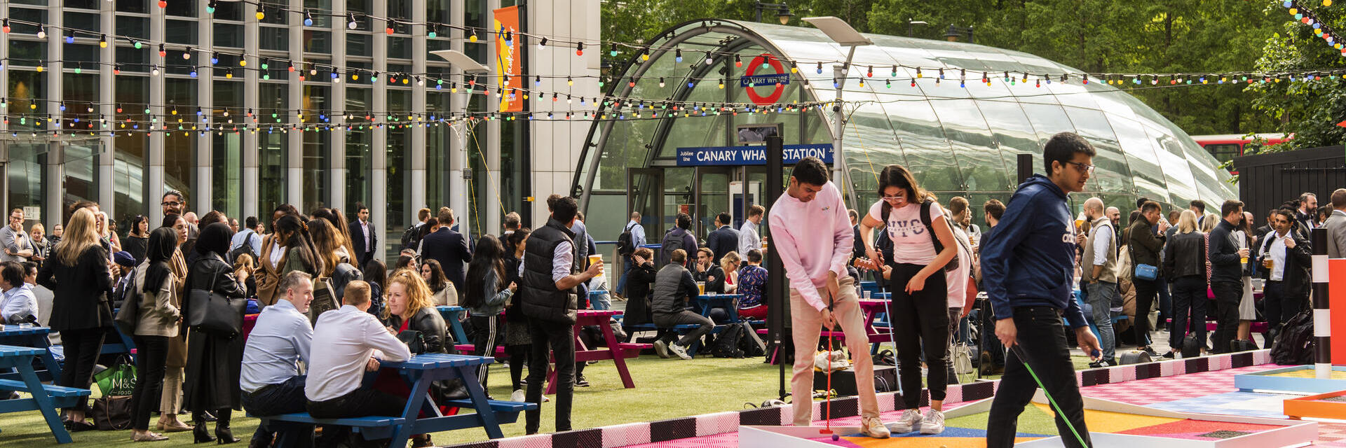 People playing mini golf at the Night Market in Canary Wharf