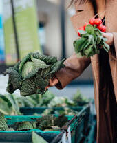 Woman shopping for fresh organic vegetables at farmer's market.