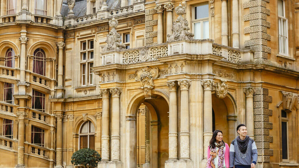 Couple walking outside a stately home