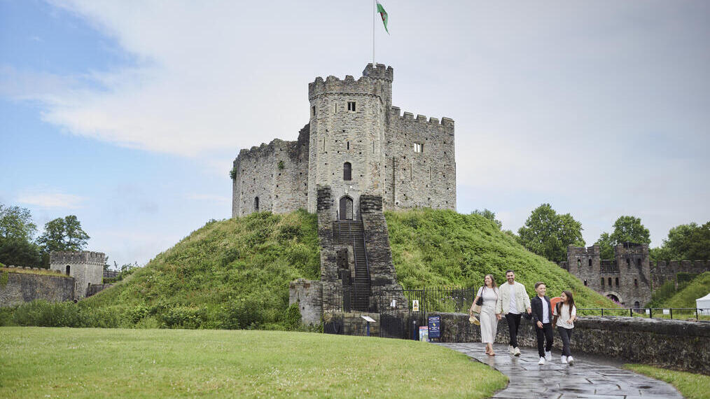 Family walking in front of a castle