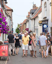 People walking through a shopping street in Wells-next-the-Sea