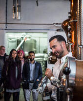A tour group being shown around a gin distillery in Leeds