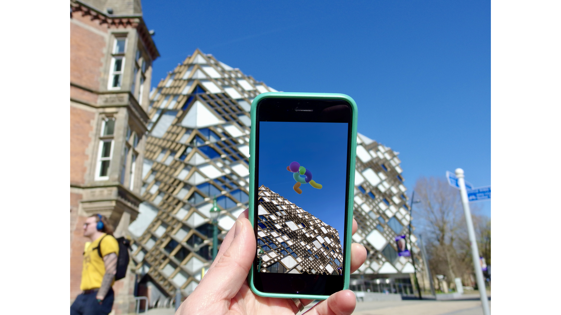An artwork being viewed through a phone using AR technology in Sheffield