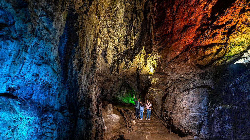 A family standing inside a cave