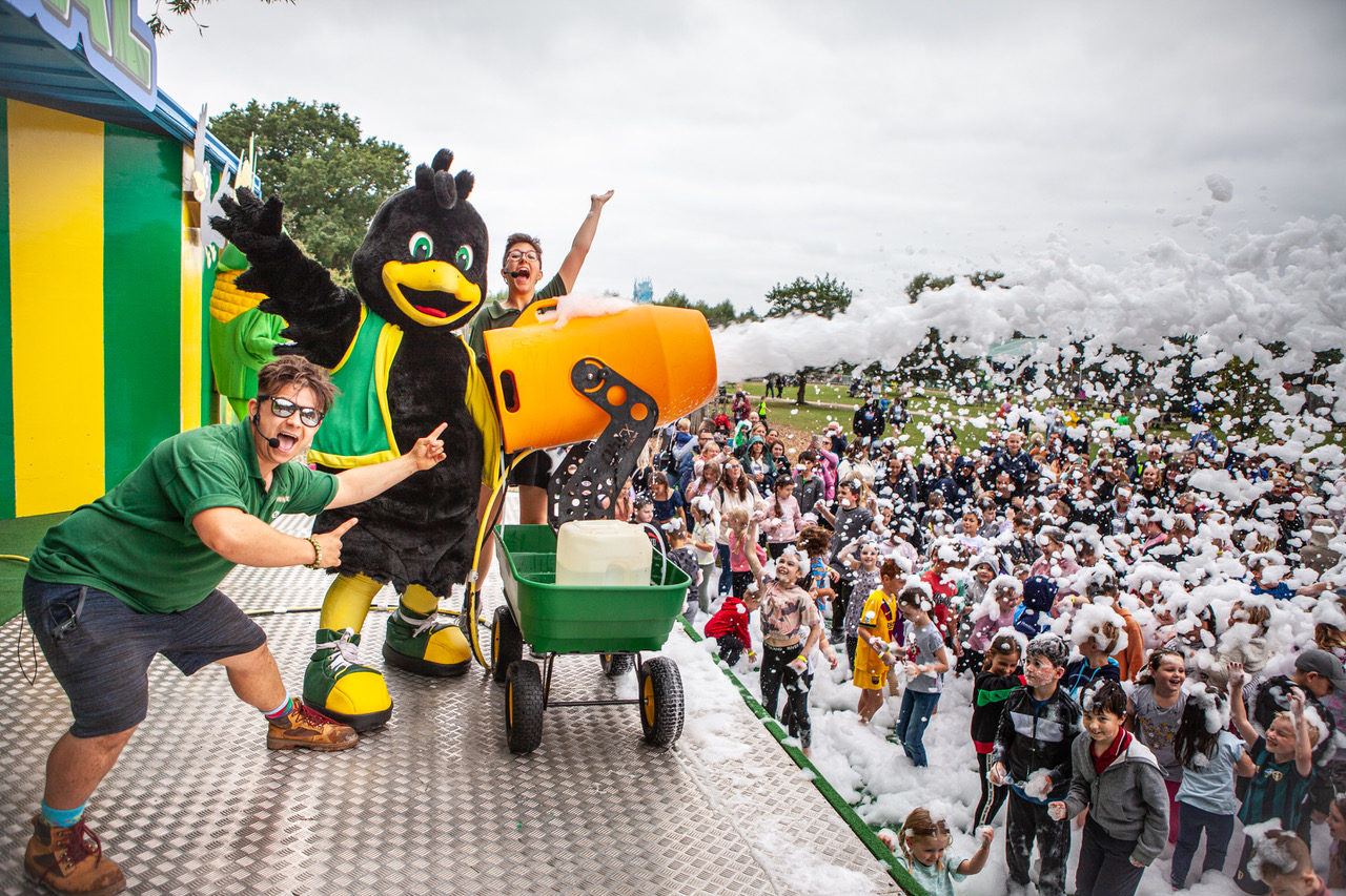 Performers on stage at York Maze shooting foam from a cannon