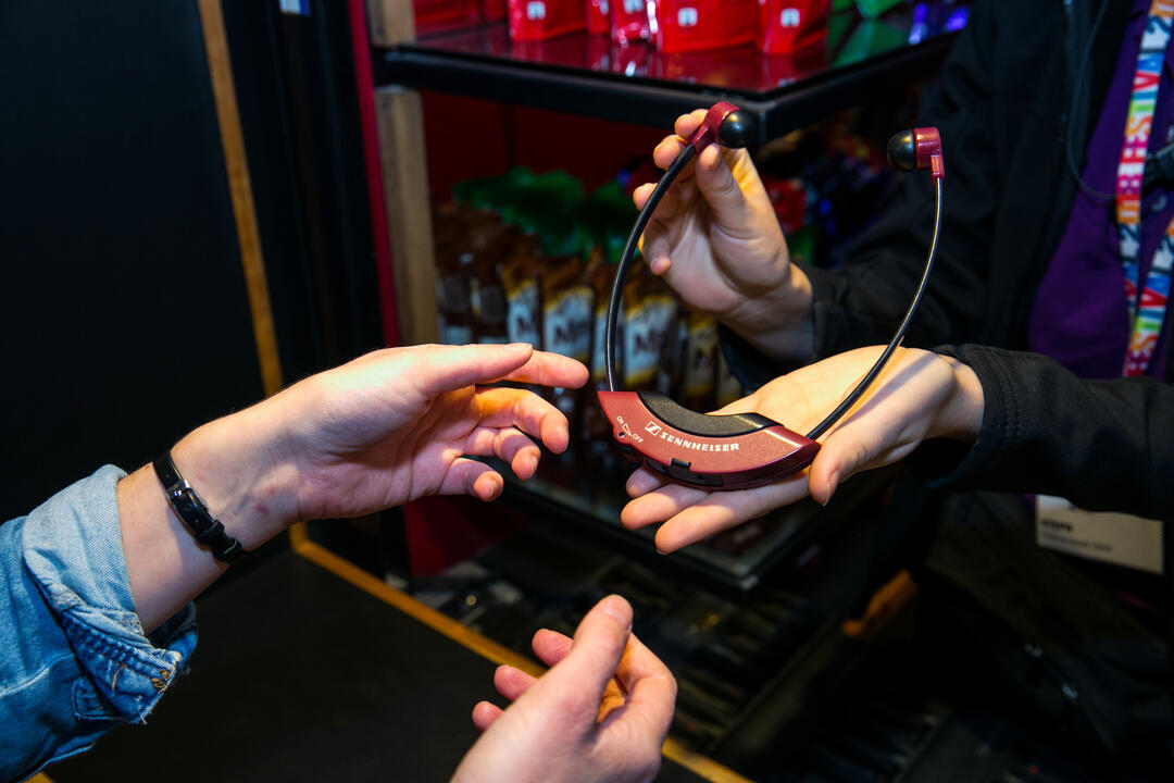 Audio Description headset being handed out