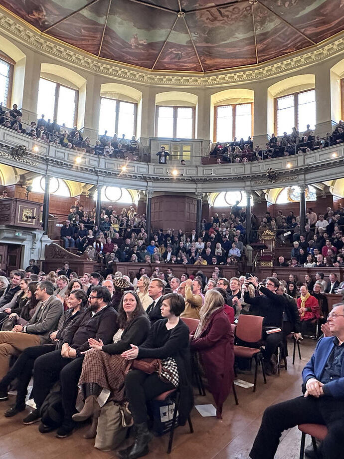 Crowds of people watching a talk on stage at Oxford Literary Festival