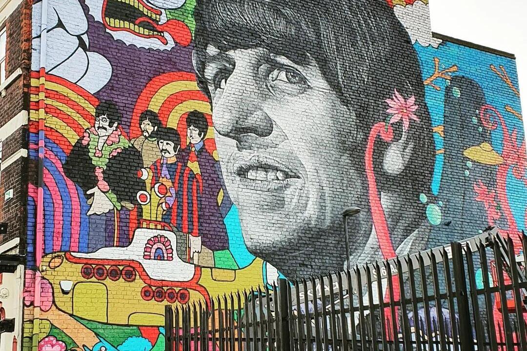 Grafitti art of the Beatles, prominently featuring Ringo Starr, on a wall in Liverpool