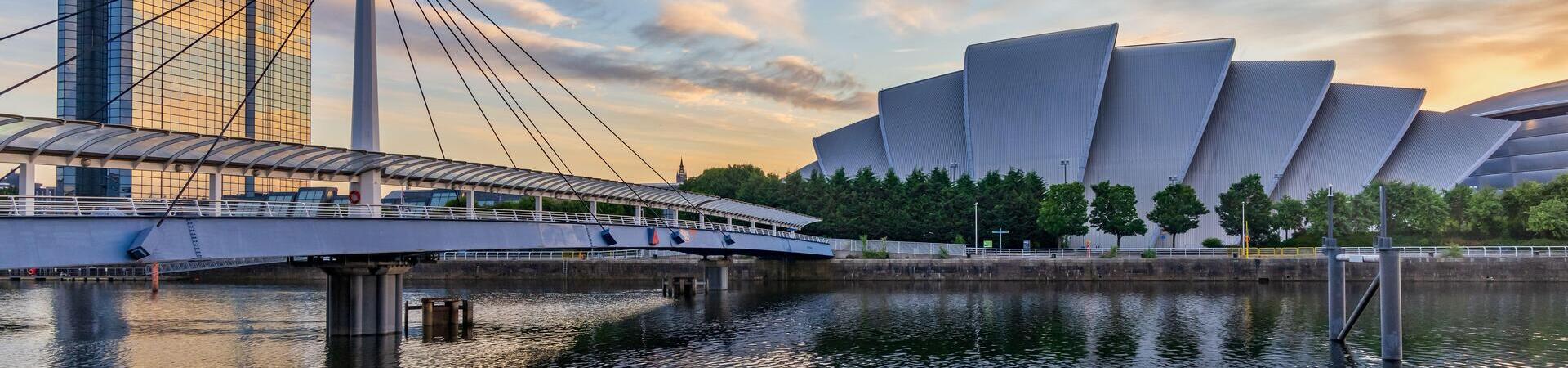 Modern building next to a river and a bridge
