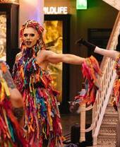 People dressed up in colourful outfits at the Manchester Museum