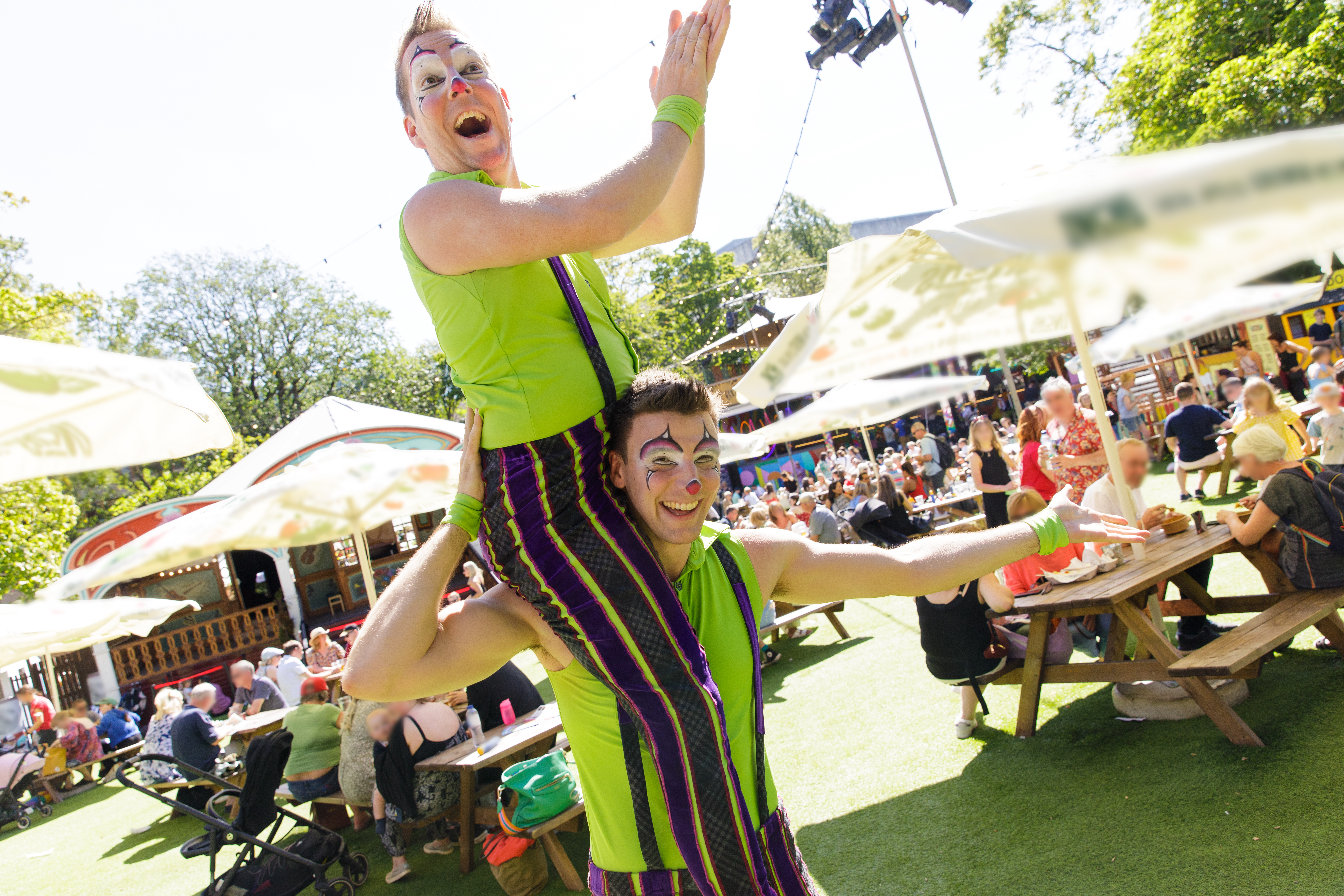 Two acrobats strike a pose at a summer festival
