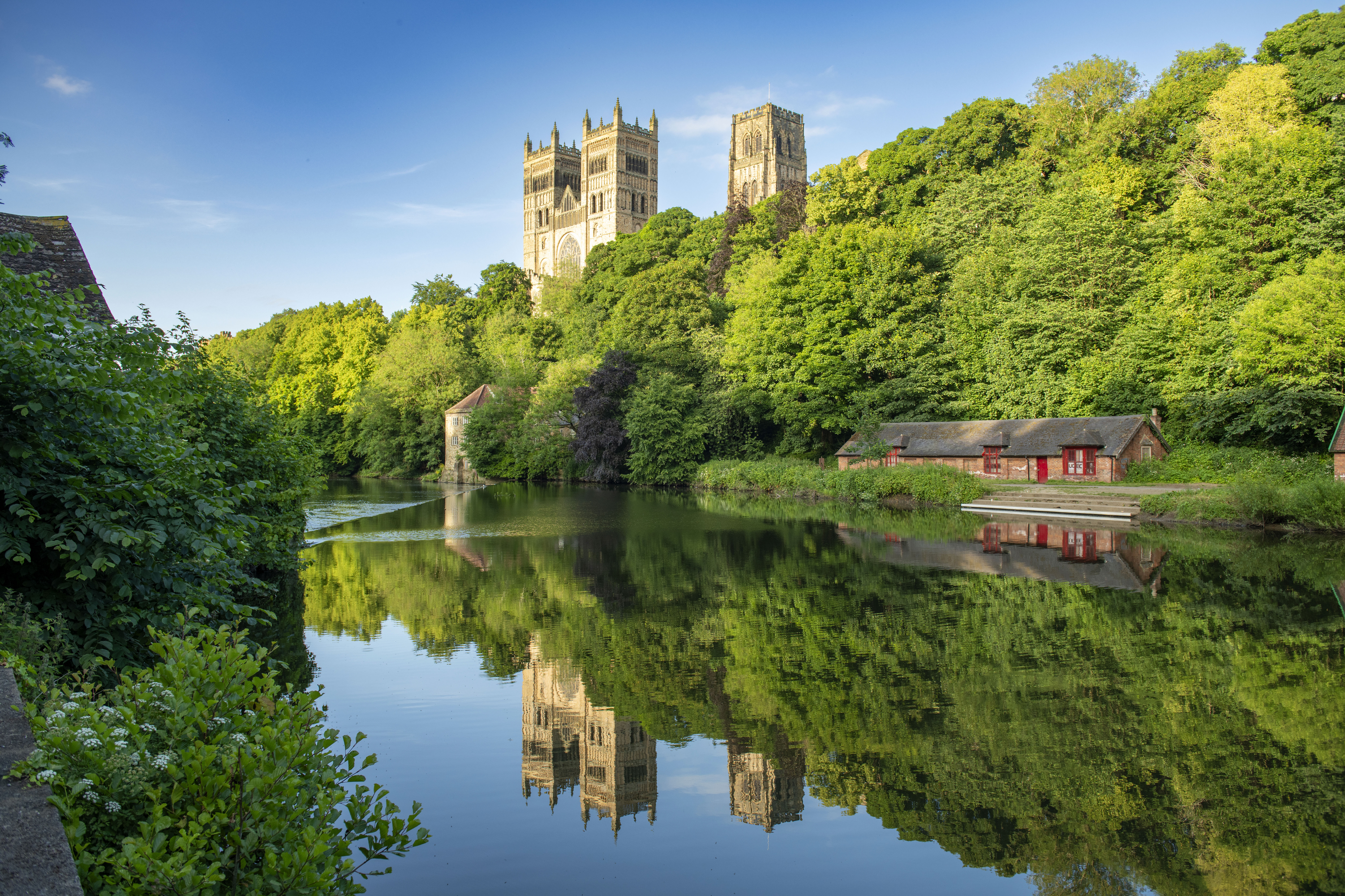 A view of a river with a Cathedral beyond.