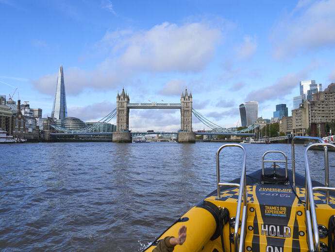 Group of people on board a speed boat on a city river