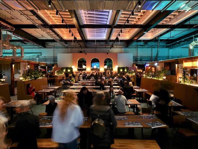 People eating food and drinking in Chester Market