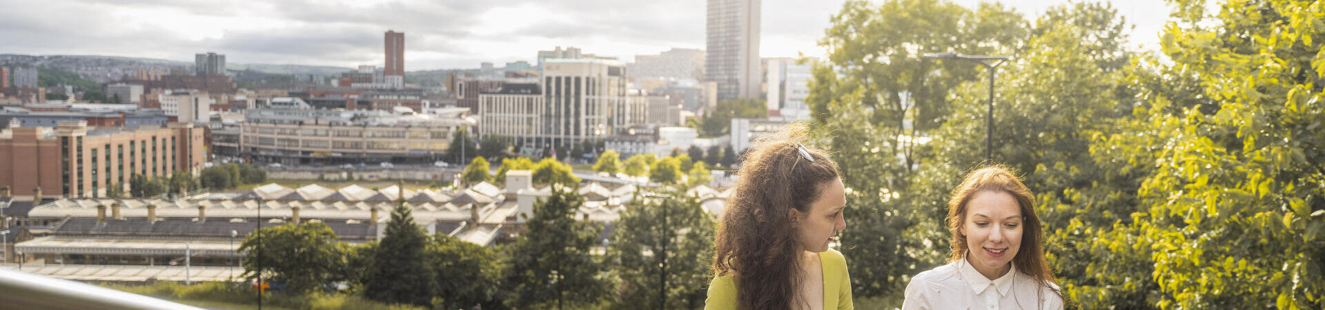 Two women in front of a city skyline