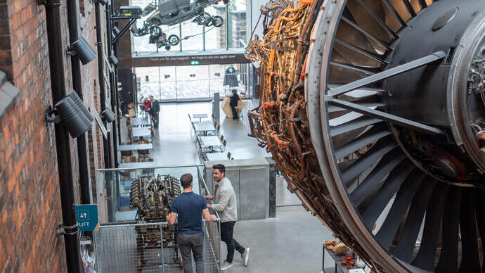 Two men stand in the atrium of a Museum