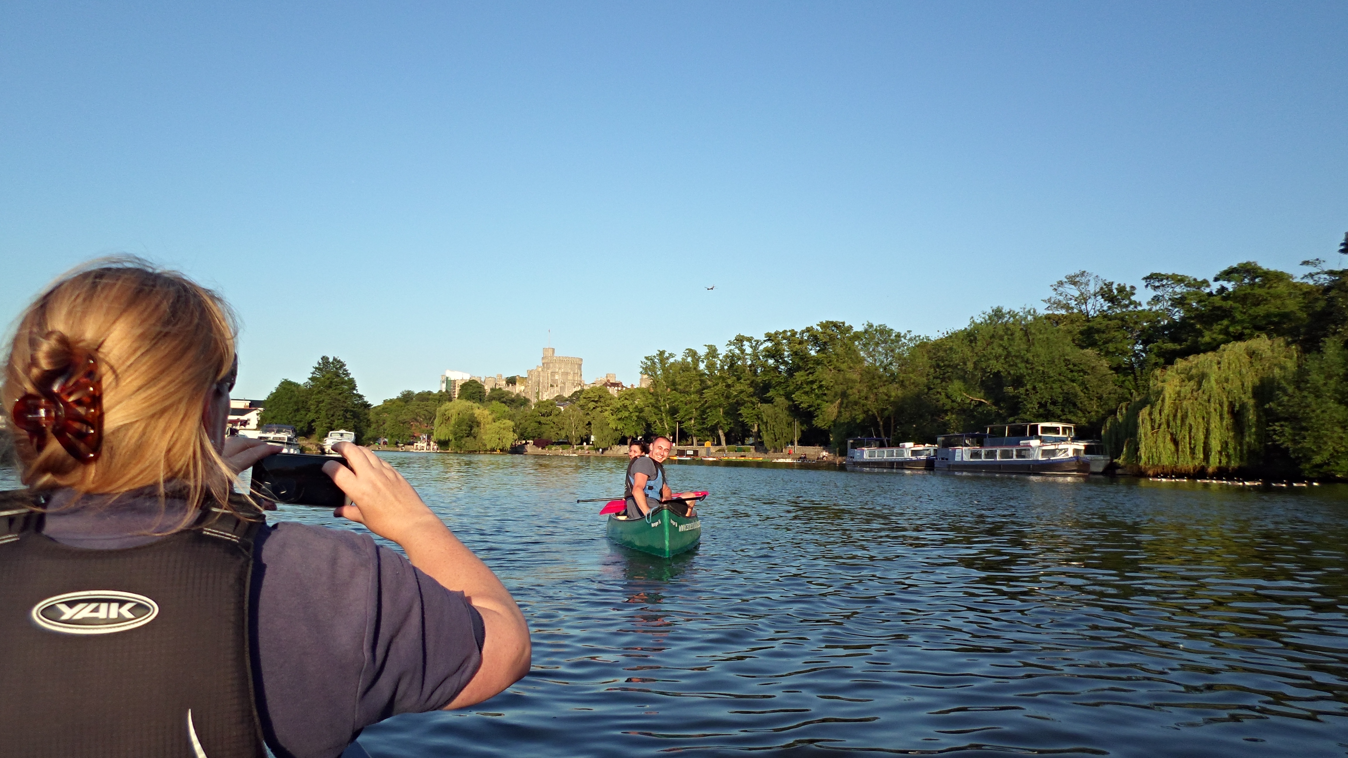 Two people on a kayak posing for a photo on the River Thames