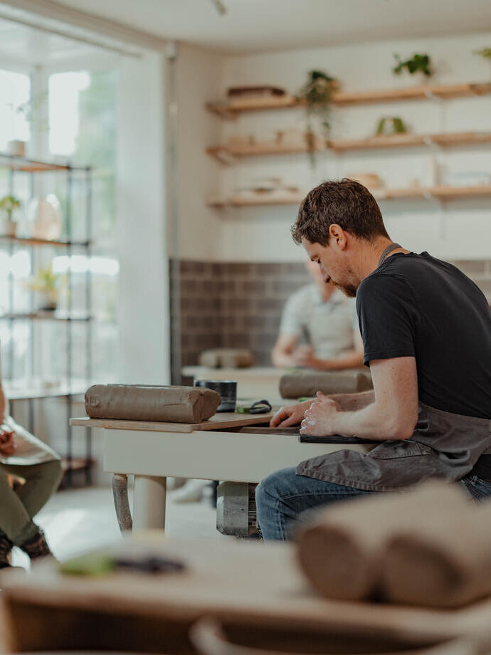People taking a pottery class.