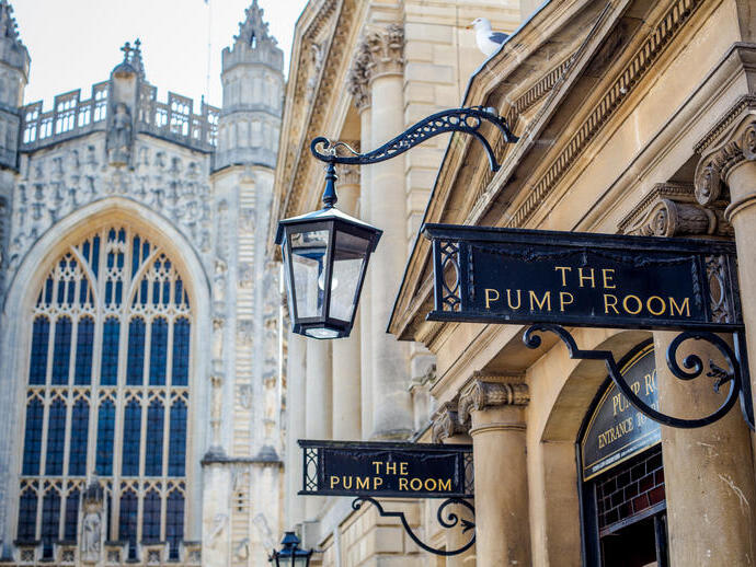 A view of the entrance to The Pump Room with a church in the background at an elegant upmarket restaurant.