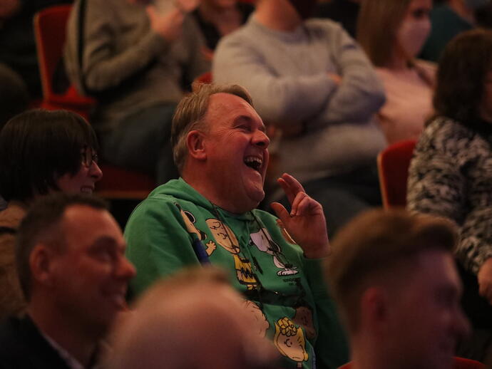 An audience member laughing during a show at Leicester's Comedy Festival