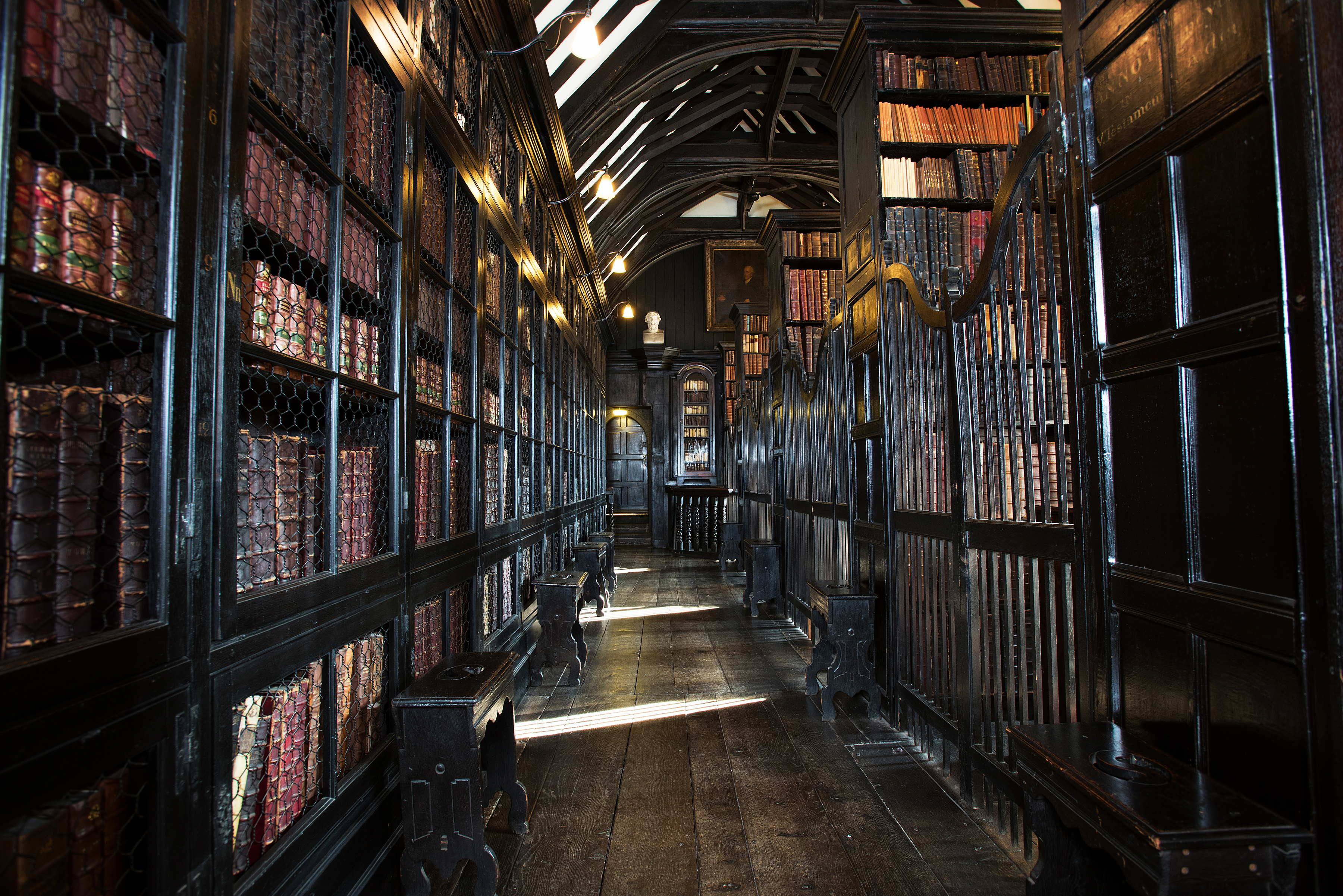 Rows of bookcases full of books in a massive old library