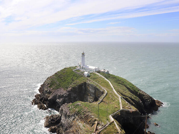 A lighthouse at the end of a peninsula