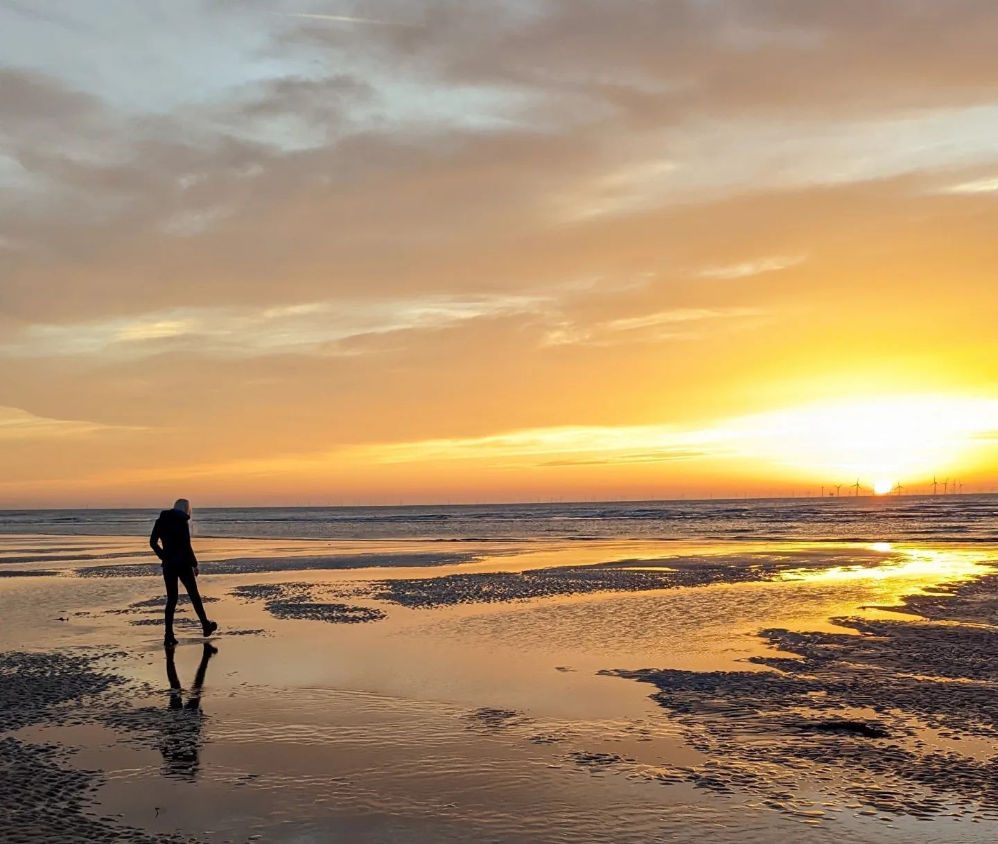 Autumn-island escape. Man walking on a beach