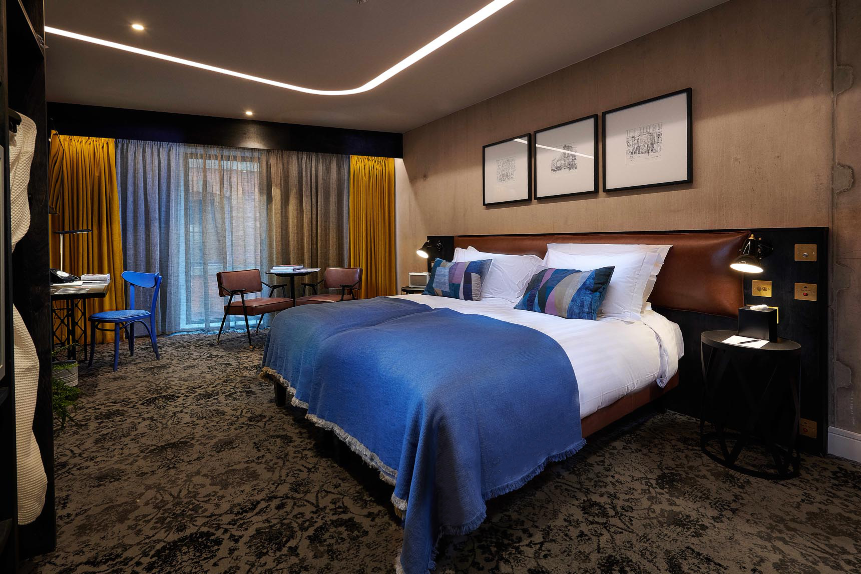 Hotel room interior with double bed and chairs