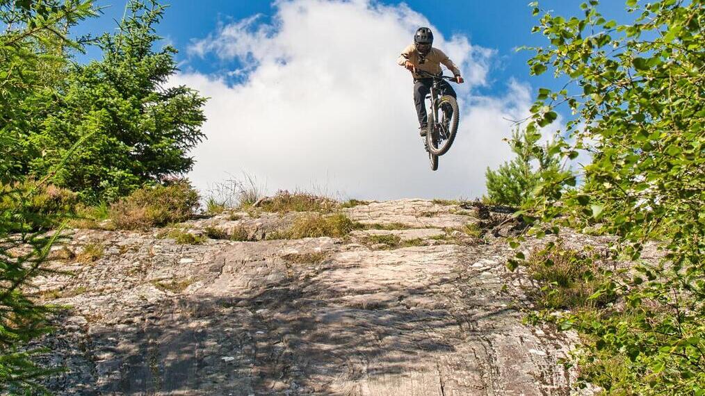 Person on bike going over hill