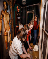 Five friends trying to work their way out of a small escape room