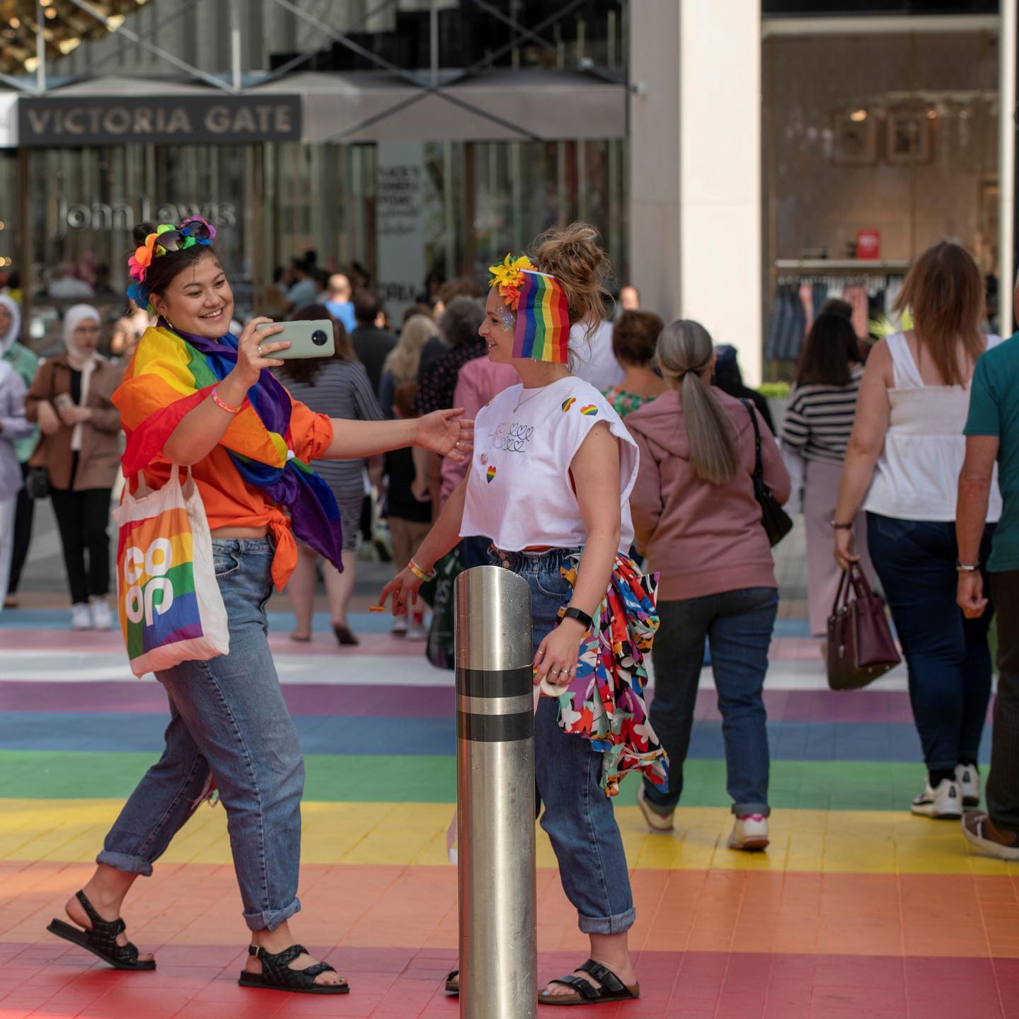 Two women dressed in Pride outfits at Victoria Gate, Leeds