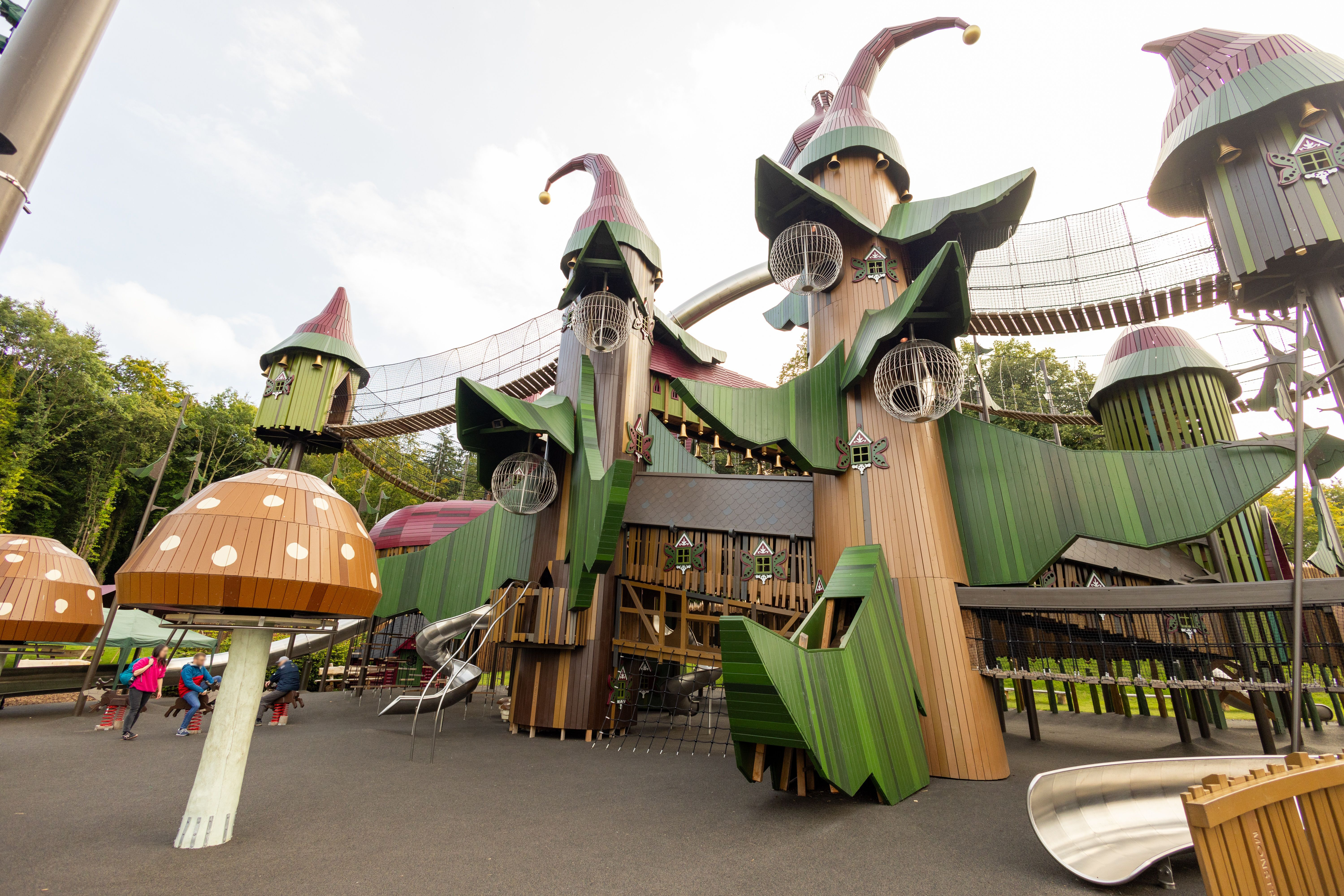 A large playground structure as part of a fantasy themed village in the grounds of a castle
