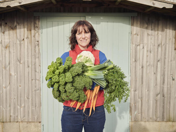 Woman holding a selection of fresh vegetables