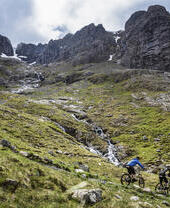 Two mountain bikers cycling down a mountain