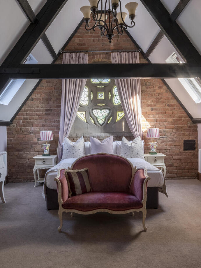 Bedroom with vaulted ceiling with beam