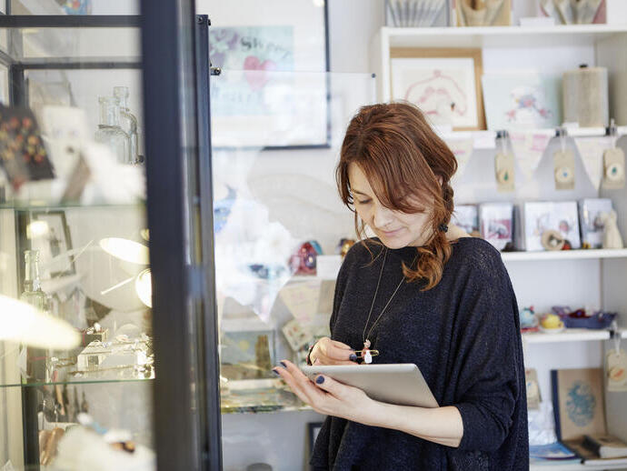 Woman working on iPad in a gift shop