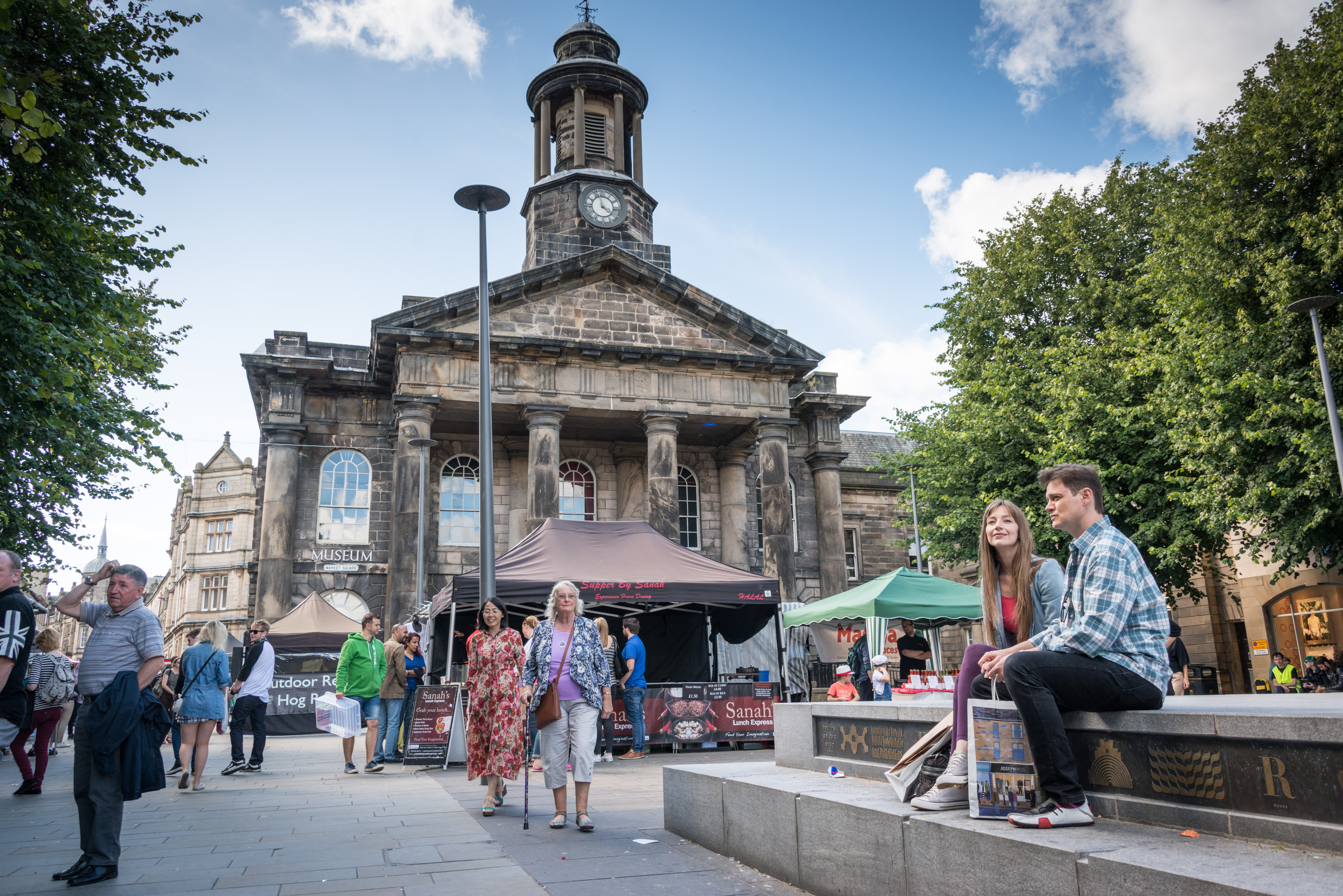 Groups of people exploring the city centre of Lancaster