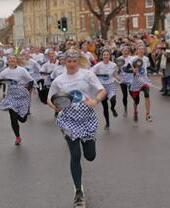 People taking part in the Olney pancake race