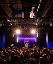 A live performance on stage at Band on the Wall in Manchester