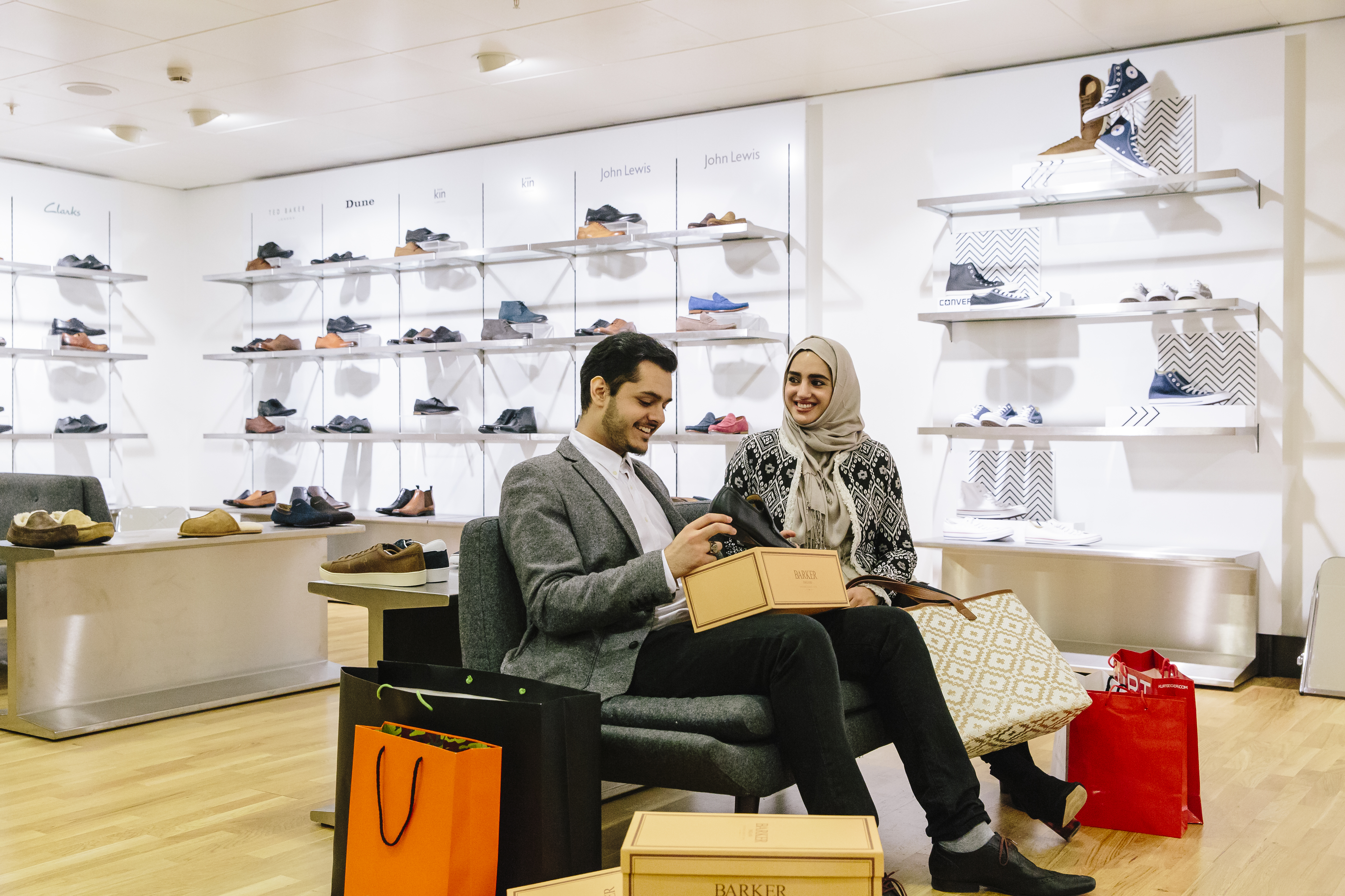 A couple of Middle Eastern ethnicity shopping for shoes