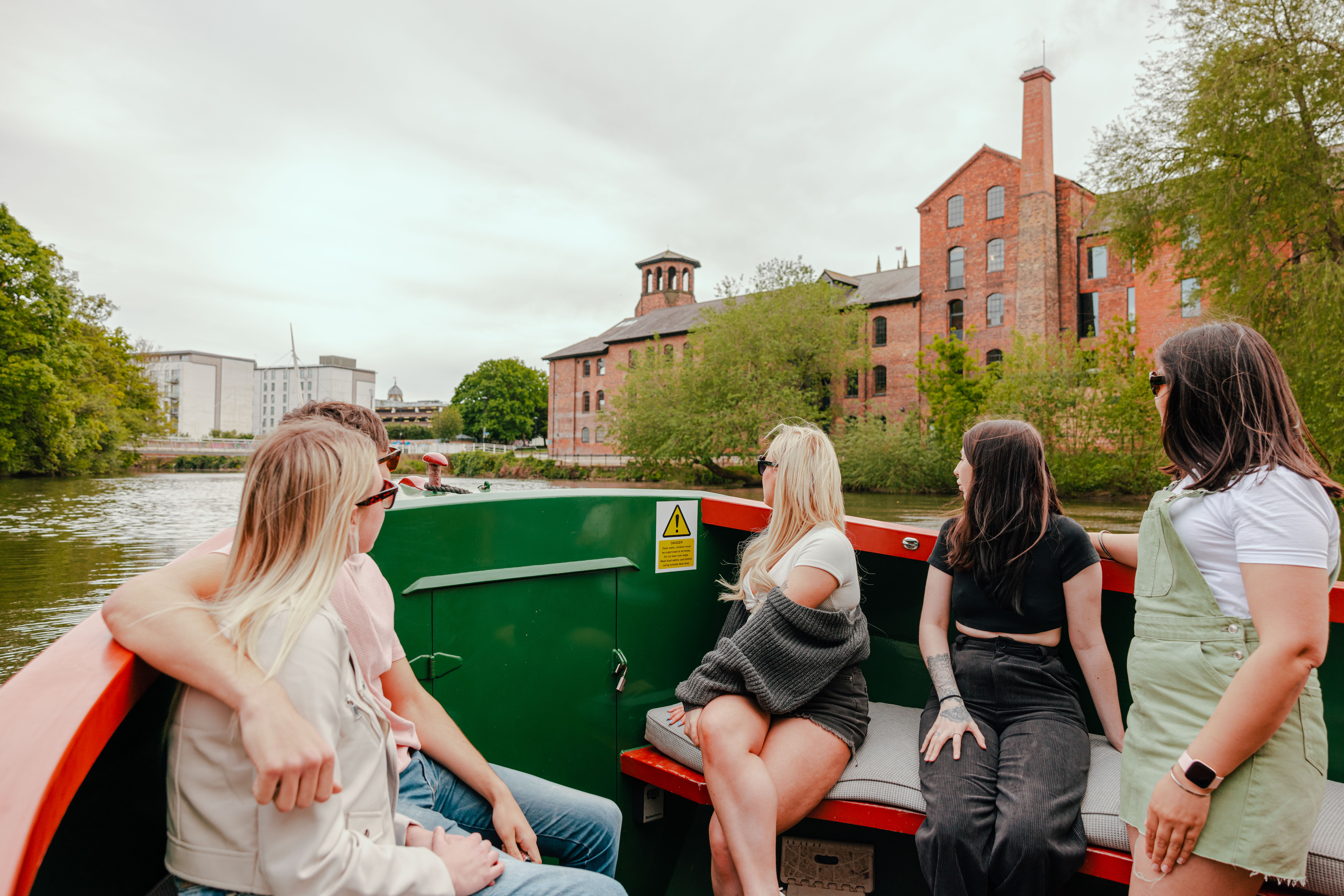 A group of people riding in a riverboat