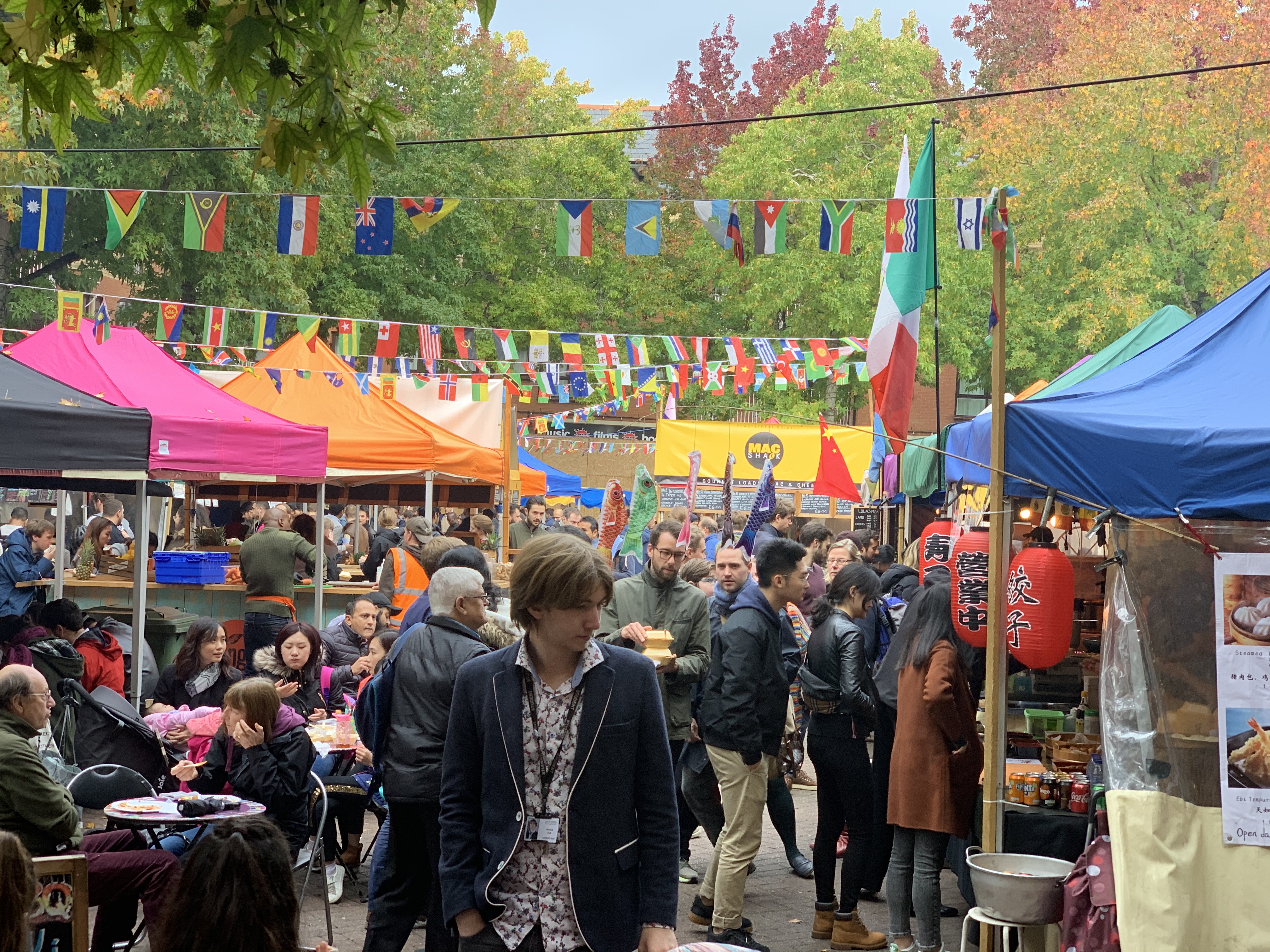 Crowds of people shopping at Gloucester Green Market in Oxford