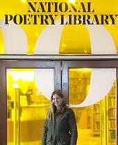A woman standing outside the National Poetry Library at the London Literary Festival