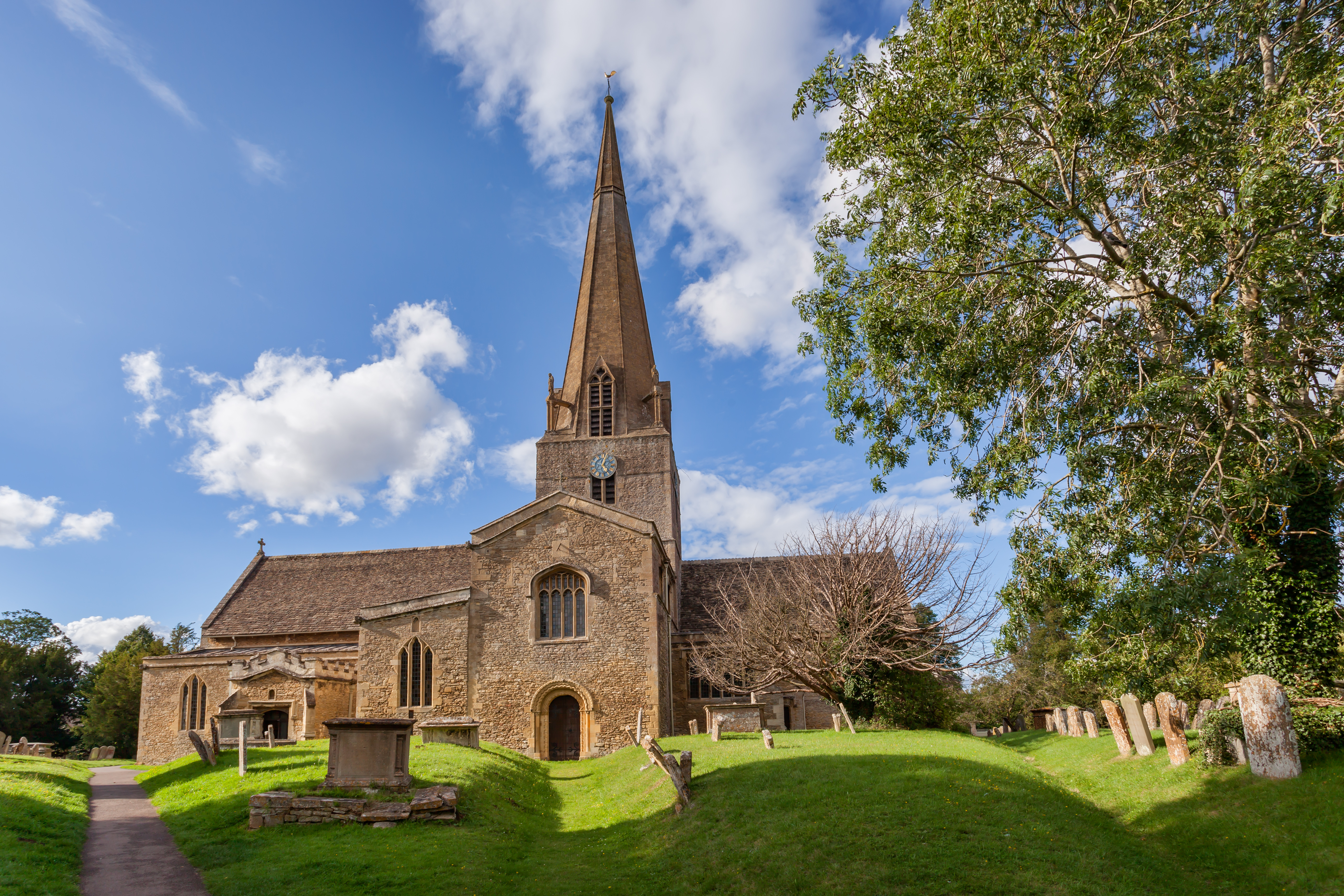 A Parish Church and its tombstones and gardens out the front.