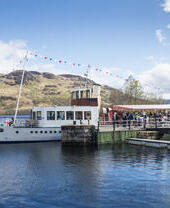 Steam boat docked on a lake