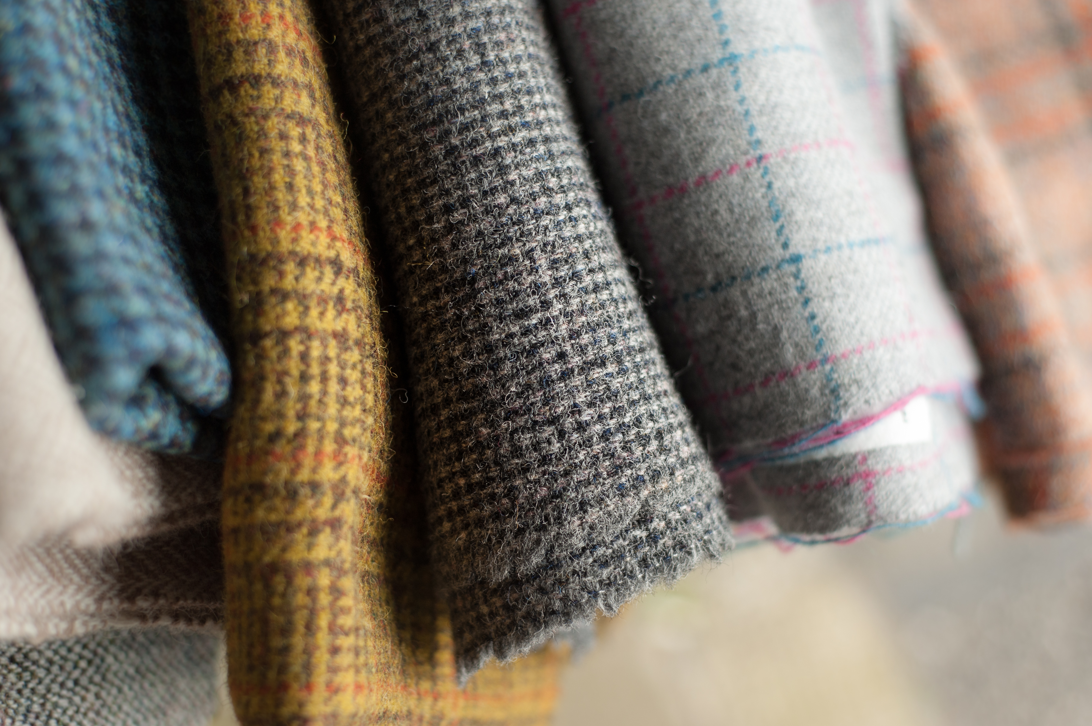 Close up variety of types of Harris Tweed showing the range of fabric available.