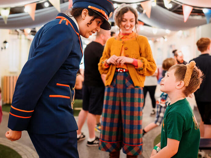 Character actors talking to a young child.