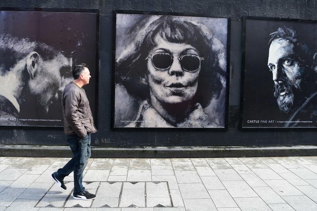 A person viewing Peaky Blinders Artwork in Birmingham.